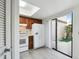Efficient kitchen with white appliances, a skylight, and a sliding door to the outdoors at 440 Woods Landing Trl, Oldsmar, FL 34677