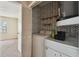 A laundry area with a washer and dryer featuring a distinctive black and white patterned wall and shelving above at 440 Woods Landing Trl, Oldsmar, FL 34677