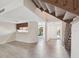 Open-concept living area with wood-look flooring, a staircase, and a view of the kitchen at 440 Woods Landing Trl, Oldsmar, FL 34677