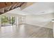 Bright living room with wood-look flooring and access to the outdoor space at 440 Woods Landing Trl, Oldsmar, FL 34677