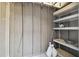 Interior storage space featuring installed shelving, concrete floor, and gray painted walls at 440 Woods Landing Trl, Oldsmar, FL 34677