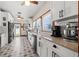 Modern kitchen featuring white cabinetry, stainless steel appliances, and patterned flooring at 4421 5Th S Ave, St Petersburg, FL 33711