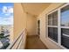 Balcony view with neutral walls, white railings, and a glimpse of the neighborhood at 4460 Fairways Blvd # 401, Bradenton, FL 34209