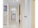 Hallway features access to laundry room and bathroom with storage closet and neutral color palette at 4460 Fairways Blvd # 401, Bradenton, FL 34209