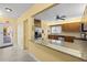 Eat-in kitchen with wood cabinetry, granite countertops, stainless steel appliances, and breakfast bar seating at 4460 Fairways Blvd # 401, Bradenton, FL 34209