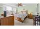 Bedroom featuring large windows, ceiling fan, and a cozy bed at 4460 Fairways Blvd # 401, Bradenton, FL 34209