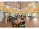 Elegant meeting room with high ceilings, chandeliers, multiple tables and chairs with community gathering space at 4460 Fairways Blvd # 401, Bradenton, FL 34209