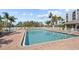 Community pool surrounded by lush landscaping and seating, offering a relaxed ambiance at 4460 Fairways Blvd # 401, Bradenton, FL 34209