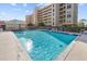 Community pool surrounded by lush landscaping and high-rise condo buildings, offers ample space at 4460 Fairways Blvd # 401, Bradenton, FL 34209
