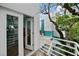 Bright balcony with white railings and views of the surrounding building and lush green trees at 4950 Bayshore Blvd # 14, Tampa, FL 33611
