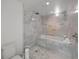 Elegant bathroom showcasing a luxurious marble-tiled bath-shower, toilet and more at 4950 Bayshore Blvd # 14, Tampa, FL 33611