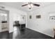 A bright bedroom showing dark wood floors, ceiling fan and a view into the next room at 4950 Bayshore Blvd # 14, Tampa, FL 33611