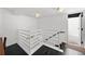 Hallway with black floors, white railing, and access to other rooms with a white door at 4950 Bayshore Blvd # 14, Tampa, FL 33611
