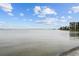 Beautiful waterfront view with calm waters, condos in the distance, and a clear sky, offering a peaceful escape at 4950 Bayshore Blvd # 14, Tampa, FL 33611