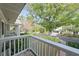 Captivating view from the balcony, overlooking a peaceful neighborhood with mature trees and gardens at 5011 S Elberon St, Tampa, FL 33611