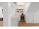 Wet bar features a marble countertop, a beverage cooler, and floating shelves for storage and display at 5011 S Elberon St, Tampa, FL 33611