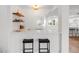 Charming bar featuring floating shelves and a marble countertop, perfect for entertaining guests in style at 5011 S Elberon St, Tampa, FL 33611