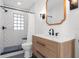 Modern bathroom with walk-in shower, new vanity, and stylish black and white tile at 5011 S Elberon St, Tampa, FL 33611