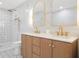 Stylish bathroom featuring dual sinks, gold fixtures, vanity and elegant tile flooring at 5011 S Elberon St, Tampa, FL 33611
