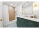Bathroom features custom vanity, gold fixtures, standing shower, and mosaic tile flooring at 5011 S Elberon St, Tampa, FL 33611