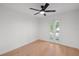 Bedroom featuring hardwood floors, a ceiling fan, and access to a private balcony at 5011 S Elberon St, Tampa, FL 33611