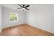 Bedroom features hardwood floors, natural light, and a ceiling fan at 5011 S Elberon St, Tampa, FL 33611