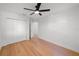 Bedroom featuring hardwood floors, ceiling fan, and closet space at 5011 S Elberon St, Tampa, FL 33611