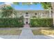 Charming townhouse featuring a manicured hedge, upper balconies and a gated entry enhancing curb appeal at 5011 S Elberon St, Tampa, FL 33611