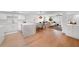 Modern open-plan kitchen with white cabinets, an island, and wood floors at 5011 S Elberon St, Tampa, FL 33611