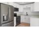 Modern kitchen with white cabinets, stainless steel appliances, and hardwood floors at 5011 S Elberon St, Tampa, FL 33611