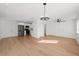 Bright open floor plan with hardwood floors, ceiling fan, and stainless steel appliances in kitchen at 5011 S Elberon St, Tampa, FL 33611