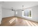 Bright, spacious living area featuring hardwood floors, a ceiling fan, and abundant natural light at 5011 S Elberon St, Tampa, FL 33611