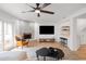 Living area features a fireplace, contemporary decor, a ceiling fan, and a clear view of the bar area at 5011 S Elberon St, Tampa, FL 33611