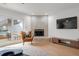 Stylish living room featuring a tiled fireplace, modern entertainment setup, and views of the outdoor pool area at 5011 S Elberon St, Tampa, FL 33611