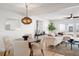 Open-concept living and dining area showcasing modern lighting, stylish furnishings, and views of the pool area at 5011 S Elberon St, Tampa, FL 33611