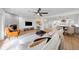 The spacious living room features a fireplace, a ceiling fan, and an open floor plan that seamlessly connects to the kitchen at 5011 S Elberon St, Tampa, FL 33611