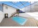 Inviting backyard pool with a screened enclosure and wooden deck, perfect for outdoor relaxation at 5011 S Elberon St, Tampa, FL 33611