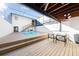 Backyard pool area with a screened enclosure, wood deck, and staircase leading to an upper level at 5011 S Elberon St, Tampa, FL 33611
