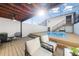 Stunning backyard pool with a screened enclosure, wooden deck, and cozy seating area at 5011 S Elberon St, Tampa, FL 33611