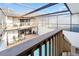 Elevated view of a captivating pool area, with decking, enclosure, and a glimpse of the home's balcony at 5011 S Elberon St, Tampa, FL 33611