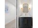 Elegant powder room boasts a decorative mirror, sconces, and a sleek vanity with marble countertop at 5011 S Elberon St, Tampa, FL 33611