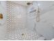 Walk-in shower featuring white marble with lattice design, and gold shower fixtures at 5011 S Elberon St, Tampa, FL 33611