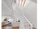 Bright staircase with wooden steps and white rails, complemented by exposed wooden beams and natural light at 5011 S Elberon St, Tampa, FL 33611