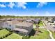 Aerial view of a large house and backyard with trees, gardens, and community neighborhood in distance under partly cloudy skies at 5407 Tagalong Pl, Apollo Beach, FL 33572