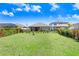 The home features a spacious, fenced backyard, ideal for pets, play, and outdoor enjoyment with ample space and green grass at 5407 Tagalong Pl, Apollo Beach, FL 33572