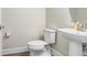 Half bath featuring pedestal sink and toilet with modern fixtures and trim at 5407 Tagalong Pl, Apollo Beach, FL 33572