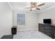 Neutral bedroom features a window with blinds, carpet flooring and modern furniture at 5407 Tagalong Pl, Apollo Beach, FL 33572