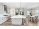 Open-concept kitchen and dining area with stainless steel appliances and a large island, perfect for entertaining at 5407 Tagalong Pl, Apollo Beach, FL 33572