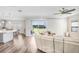 Open-concept living room with wood floors and sliding doors leading to a backyard view at 5407 Tagalong Pl, Apollo Beach, FL 33572