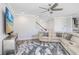Cozy living room with a large sectional couch, ceiling fan, and mounted TV at 5407 Tagalong Pl, Apollo Beach, FL 33572